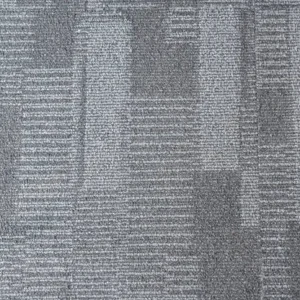 grey textured carpet tiles installed in a modern office space.