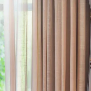 beige chiffon curtains with tassel tieback styled near window for elegant interior