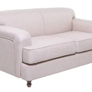 beige fabric cushions arranged on a modern sofa in a soft neutral living room.