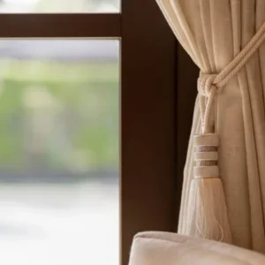 beige linen curtain with decorative tassel tieback in elegant interior