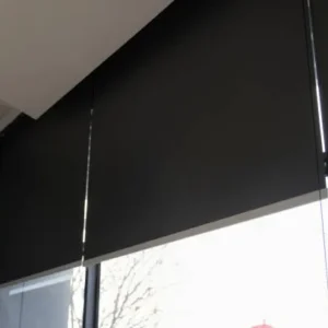 Black roller blinds in a contemporary modern interior space.
