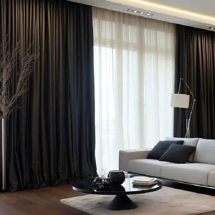 Luxury black blackout curtains with white sheers in a stylish Dubai lounge interior.