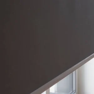 Close-up of blackout roller blind fabric texture showing light-blocking material.