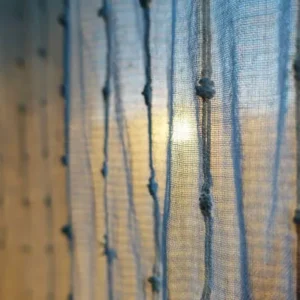 blue woven curtains with vertical thread pattern and soft light
