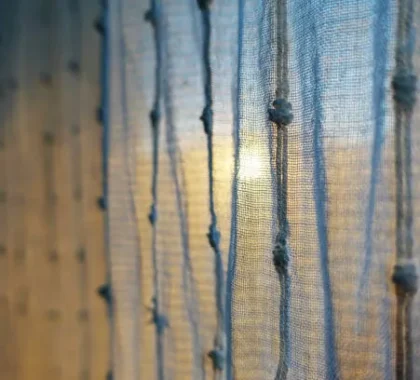 blue woven curtains with vertical thread pattern and soft light