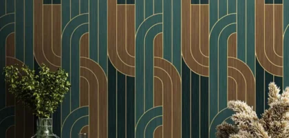 Modern interior with green and gold geometric wallpaper behind decorative plants and table setup in Dubai