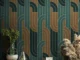 Modern interior with green and gold geometric wallpaper behind decorative plants and table setup in Dubai