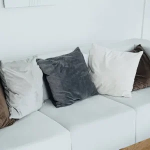 grey upholstered sofa with multiple cushions in a modern Dubai living room.