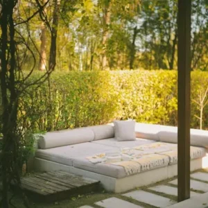 L shaped outdoor sofa with weather resistant upholstered cushions on patio.