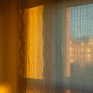 minimal sheer curtains allowing bright sunlight into modern interior