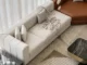 Cream upholstered sofa set in a bright Dubai living room with sheer curtains, wooden coffee table, and flooring.