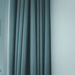 modern fabric curtain placed beside window in minimal interior setup