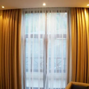 motorized curtains with sheer layer in cozy bedroom with warm lighting