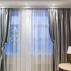 motorized curtains with sheer and blackout layers in modern living room with ceiling track
