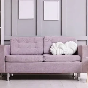 pastel purple couch upholstery in a modern styled living room with shelves.