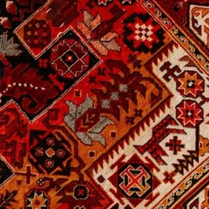 traditional red patterned carpet flooring used in a majlis style seating area.