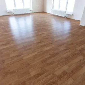 wood look vinyl flooring in an empty modern room in Dubai apartment.